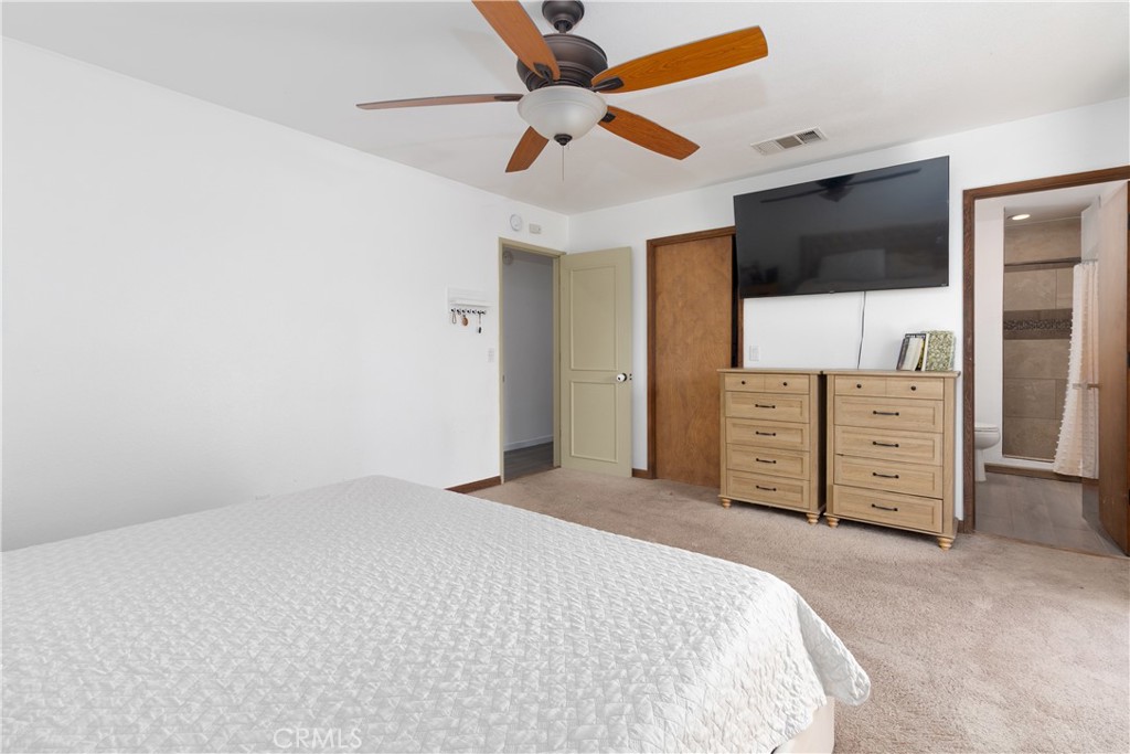 19801 Talihina Road Apple Valley, CA 92307 - Photo 16 of 32 a bedroom with a bed and a flat screen tv