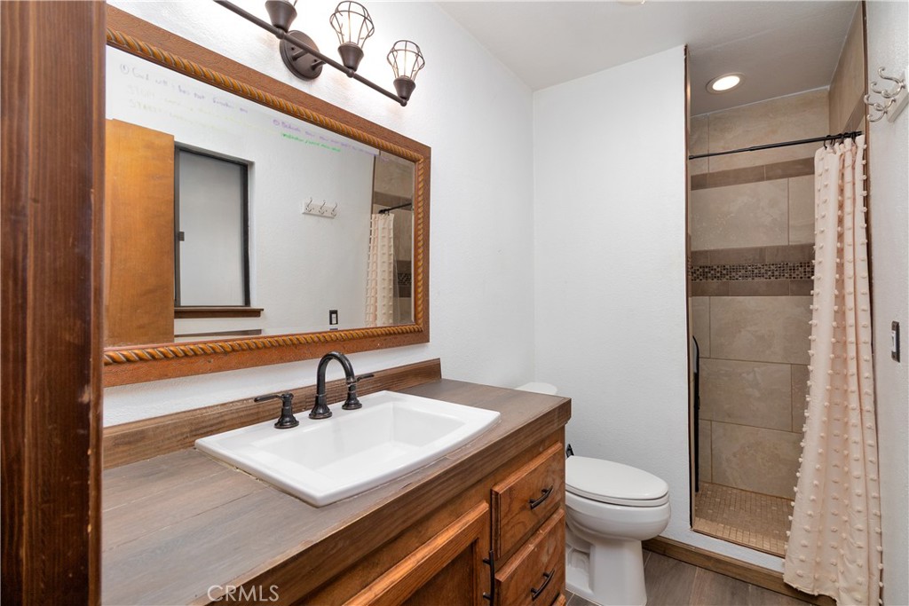 19801 Talihina Road Apple Valley, CA 92307 - Photo 17 of 32 a bathroom with a sink a toilet and mirror