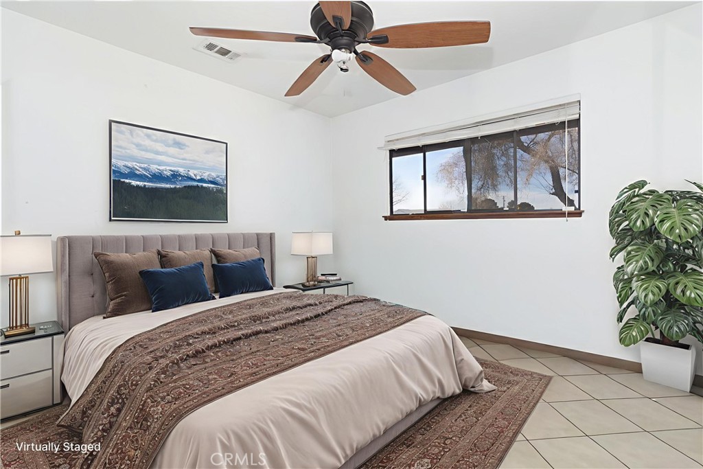 19801 Talihina Road Apple Valley, CA 92307 - Photo 19 of 32 a bedroom with bed and paintings on the wall