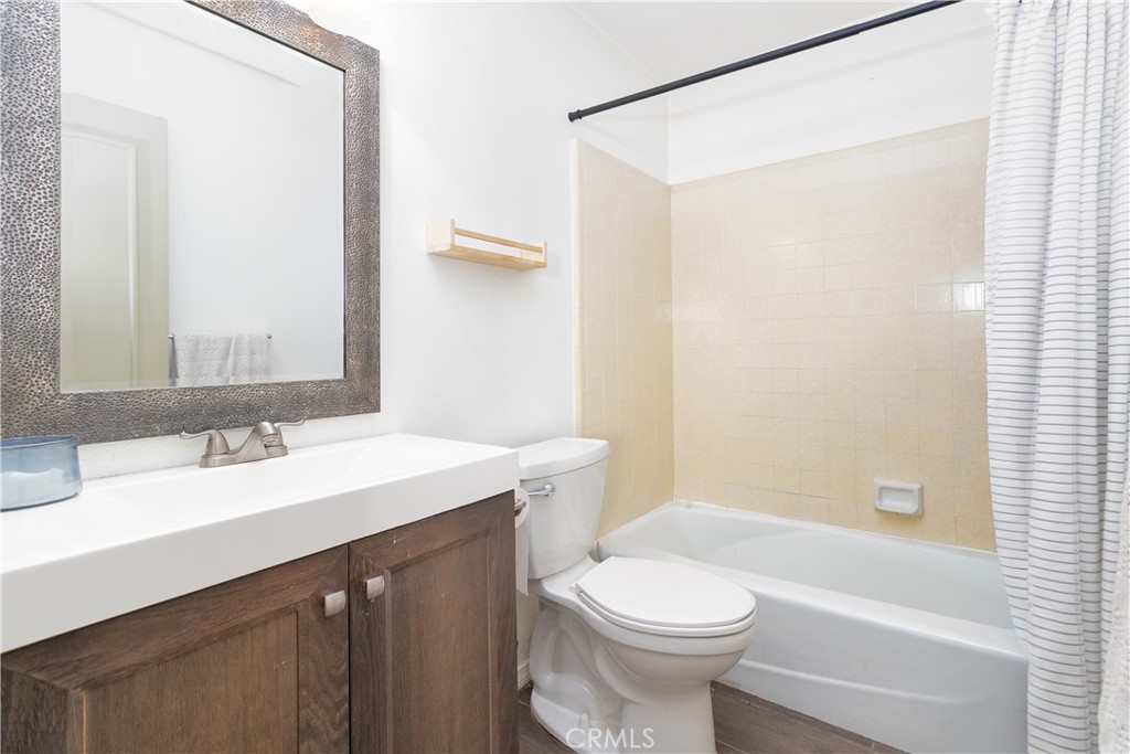 19801 Talihina Road Apple Valley, CA 92307 - Photo 21 of 32 a bathroom with a sink a toilet a mirror and shower