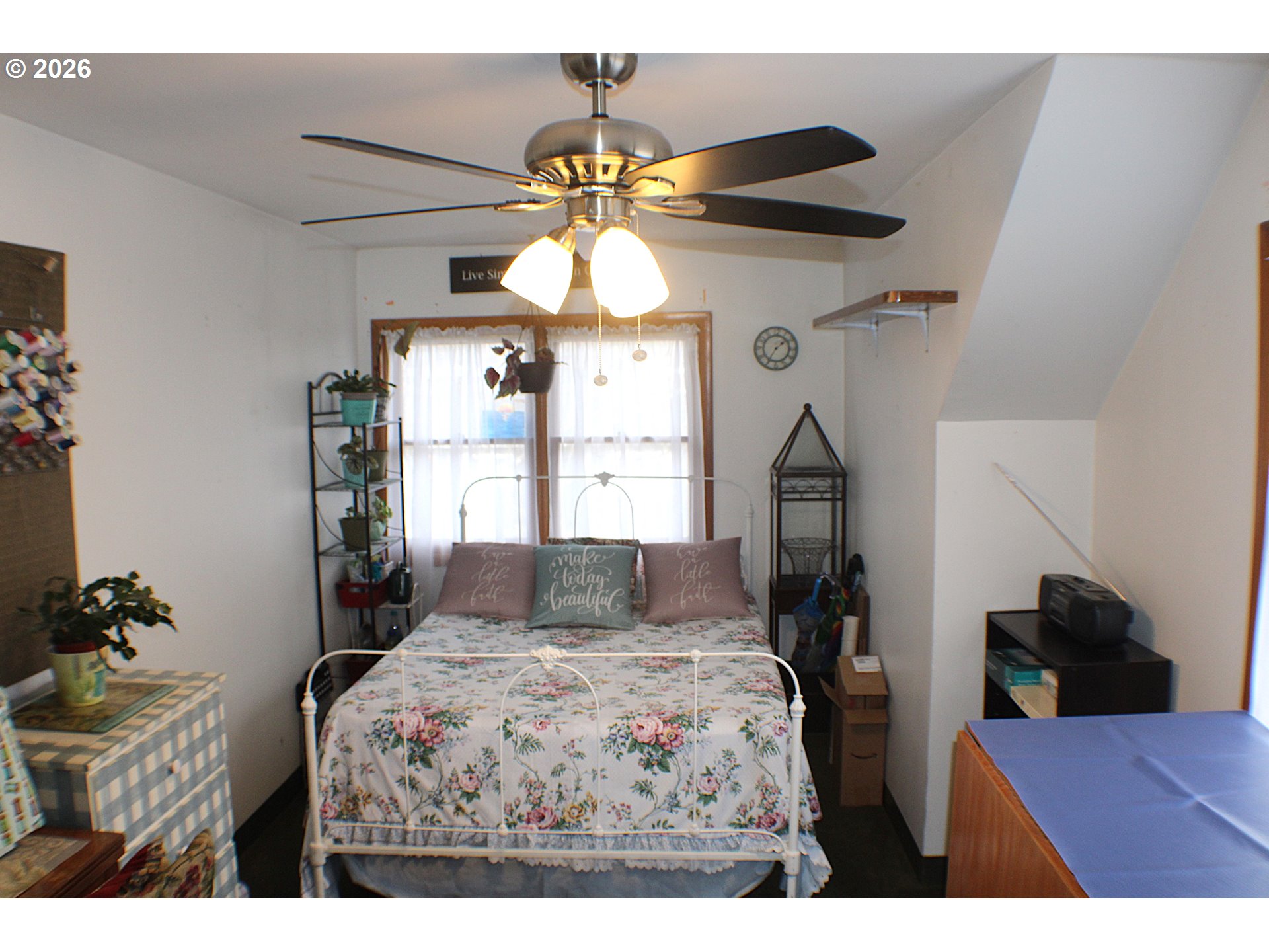 212 Park Street Riddle, OR 97469 - Photo 19 of 34 a bedroom with a bed dresser and a chandelier