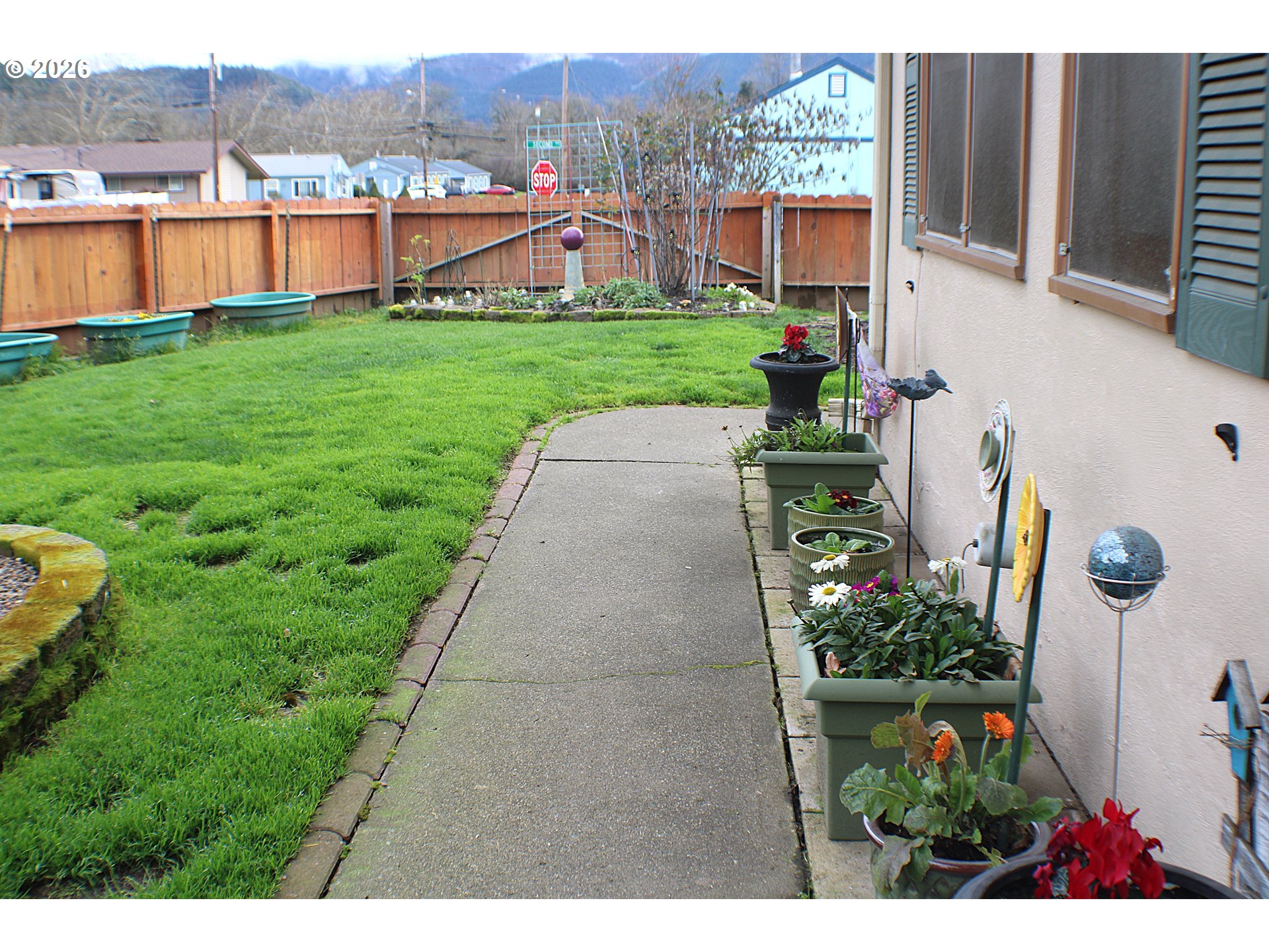 212 Park Street Riddle, OR 97469 - Photo 2 of 34 a view of a house with a garden view