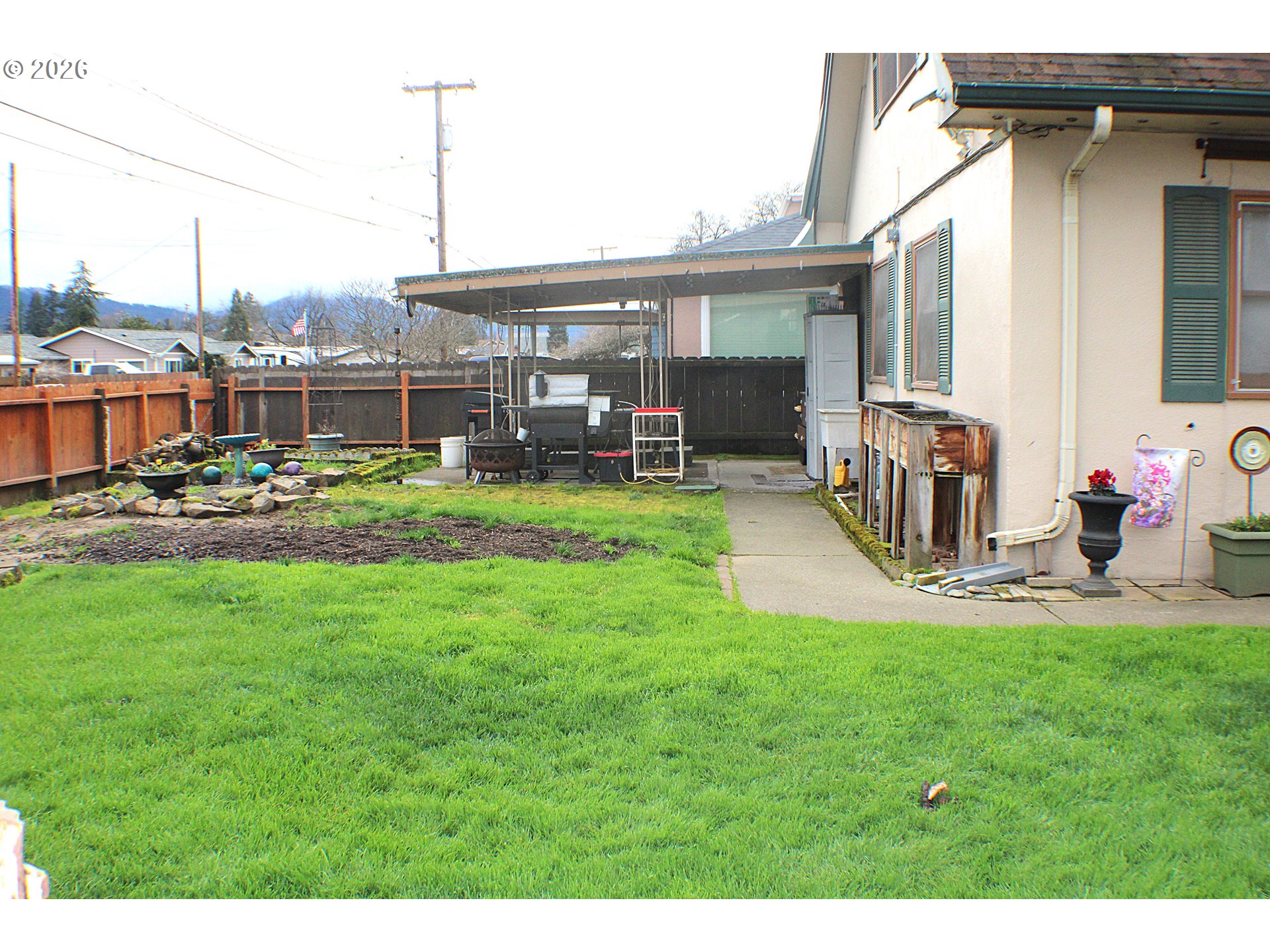 212 Park Street Riddle, OR 97469 - Photo 4 of 34 a view of a house with a backyard porch and sitting area