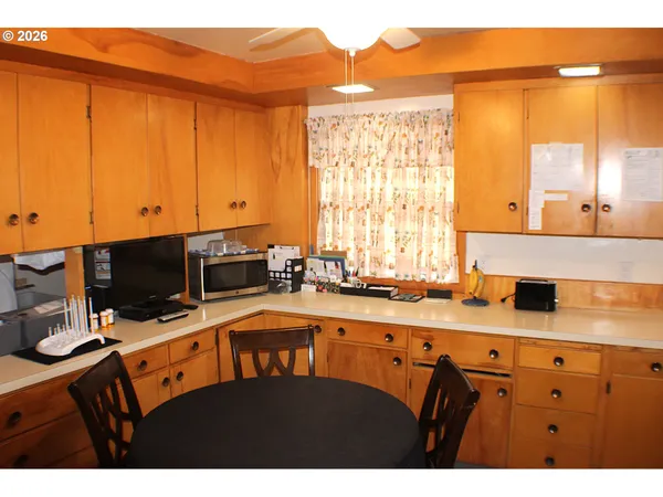 a kitchen with stainless steel appliances granite countertop a sink dishwasher and a microwave with wooden cabinets