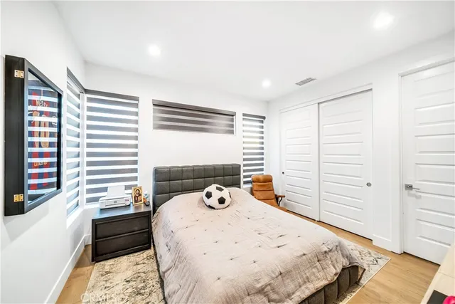 a living room with stainless steel appliances kitchen island lots of furniture and chandelier