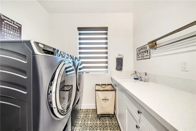 a room with pool table flat screen tv and windows