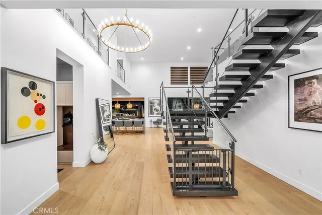 a view of a patio with table and chairs potted plants with wooden floor and fence