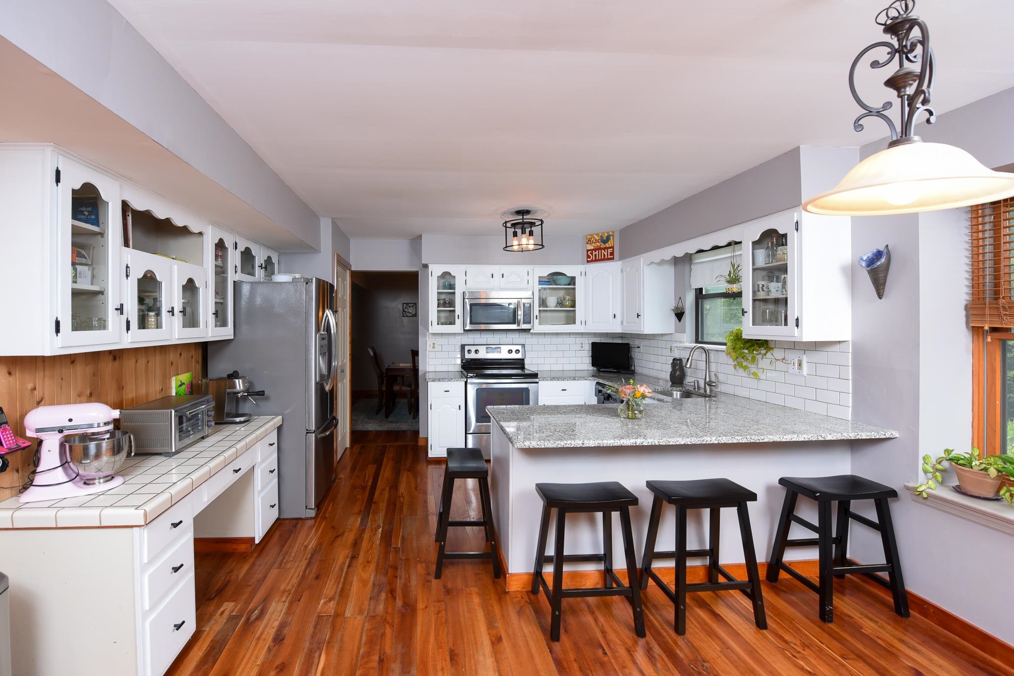 5 Inlet Ocean View, NJ 08230 - Photo 13 of 34 a kitchen with stainless steel appliances granite countertop a stove top oven a refrigerator a dining table and chairs with wooden floor