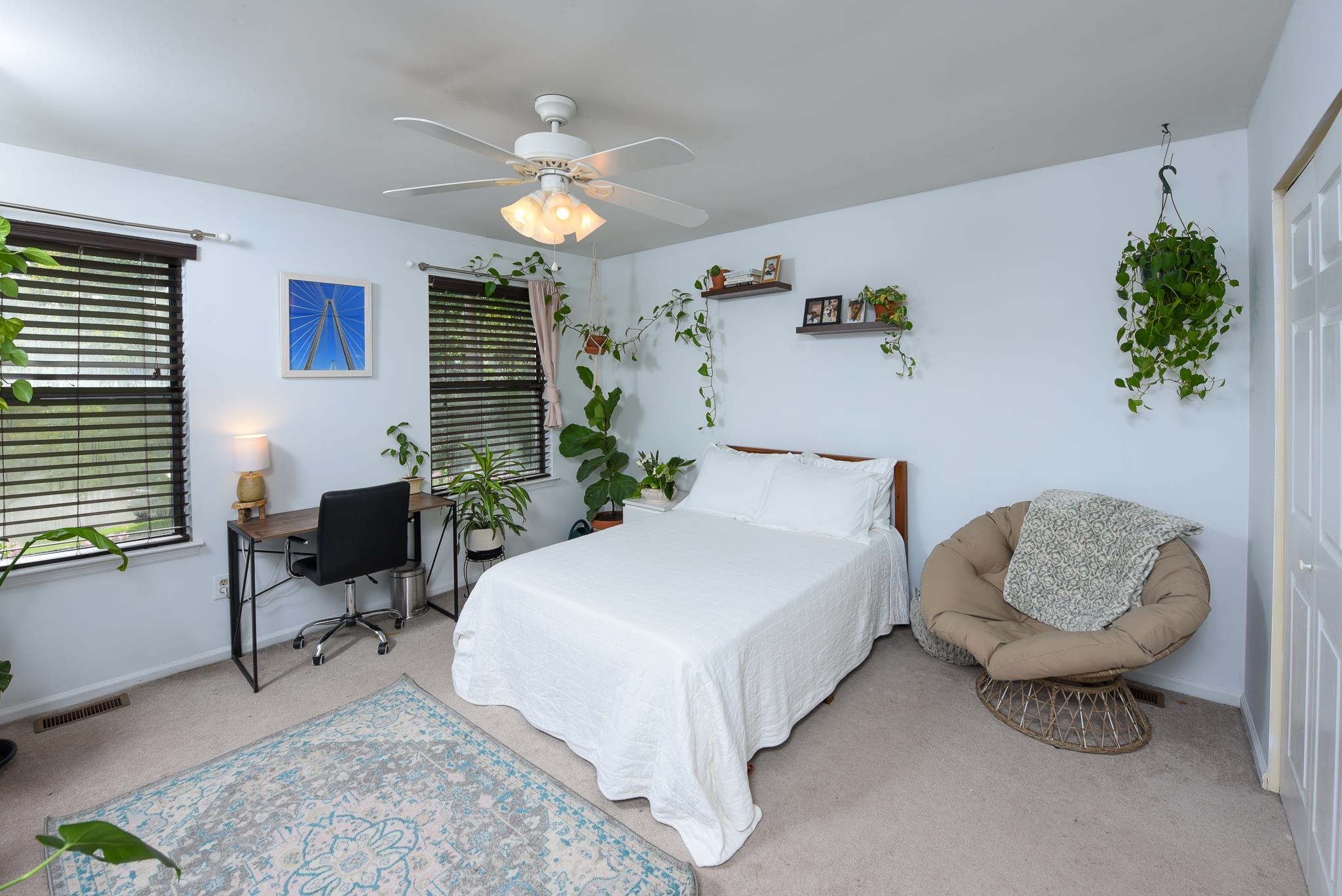 5 Inlet Ocean View, NJ 08230 - Photo 30 of 34 a spacious bedroom with a bed and a chandelier