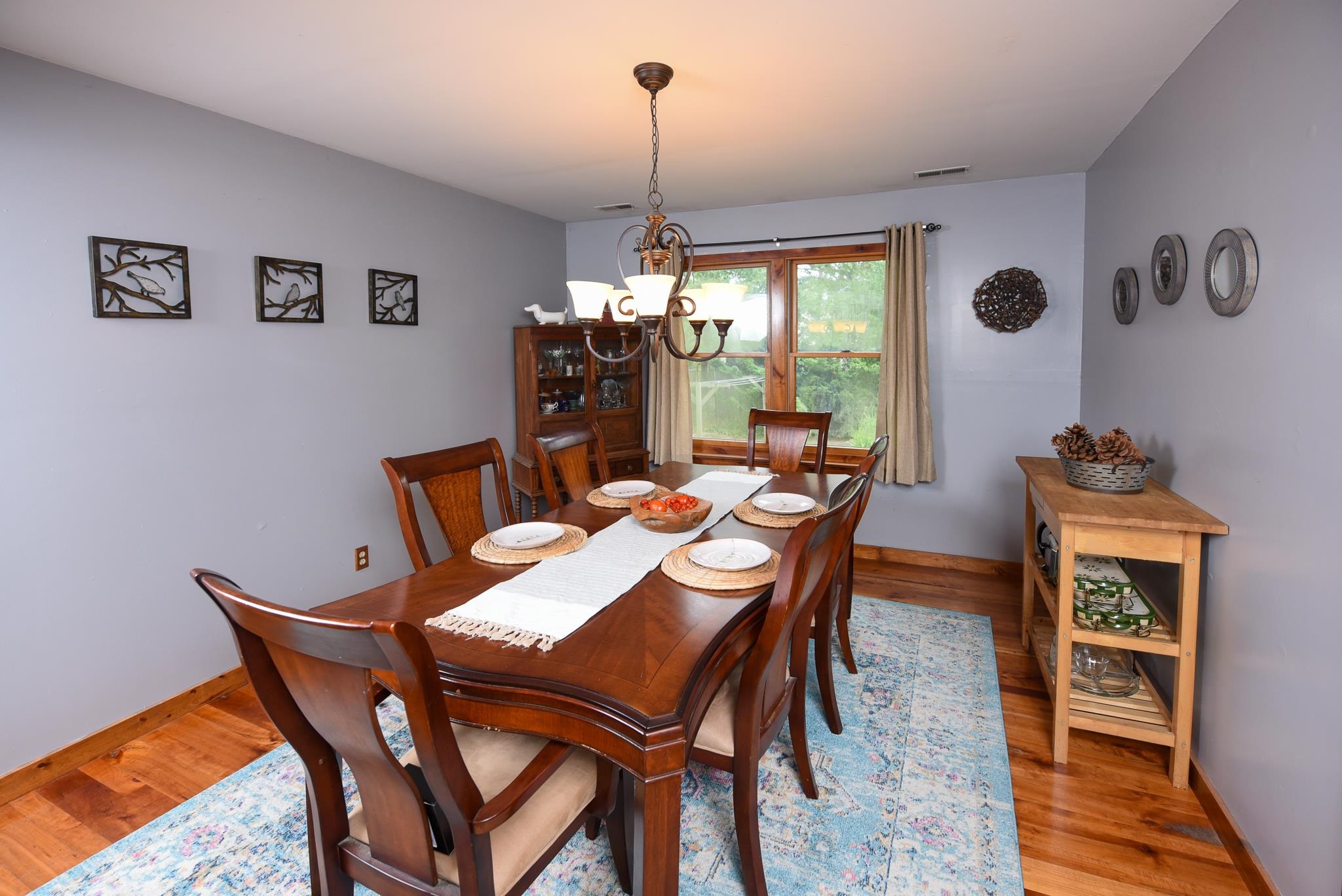 5 Inlet Ocean View, NJ 08230 - Photo 9 of 34 a dining room with furniture a chandelier and wooden floor