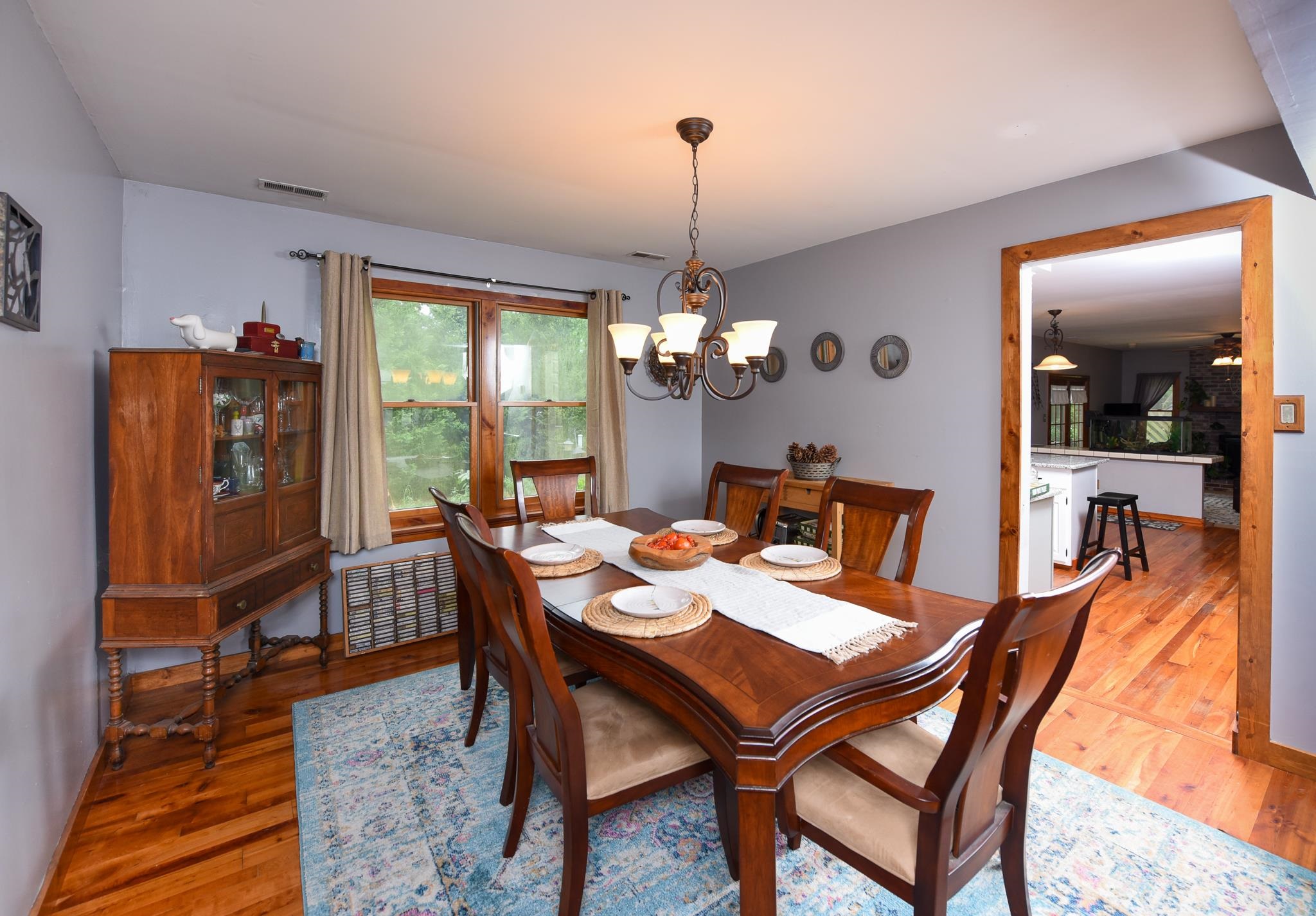 5 Inlet Ocean View, NJ 08230 - Photo 10 of 34 a dining room with furniture a chandelier and wooden floor