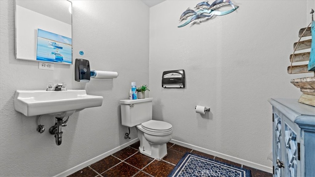 580 East Foothill Boulevard Azusa, CA 91702 - Photo 14 of 36 a bathroom with a sink toilet and a mirror
