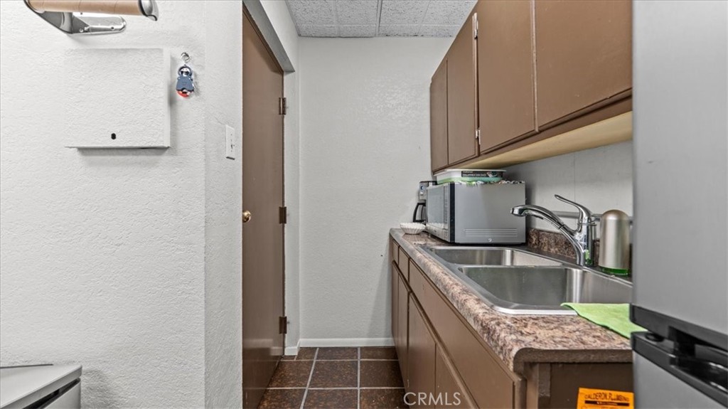 580 East Foothill Boulevard Azusa, CA 91702 - Photo 17 of 36 a kitchen that has a sink and a stove