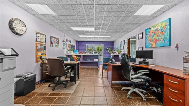 a view of a workspace with furniture and a window