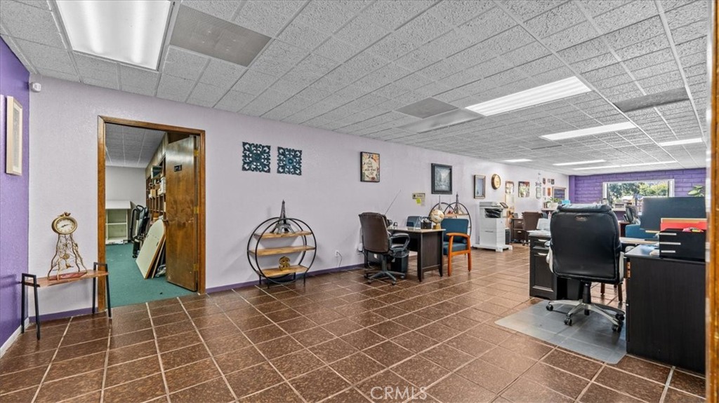 580 East Foothill Boulevard Azusa, CA 91702 - Photo 6 of 36 a room with furniture a flat screen tv and gym equipment