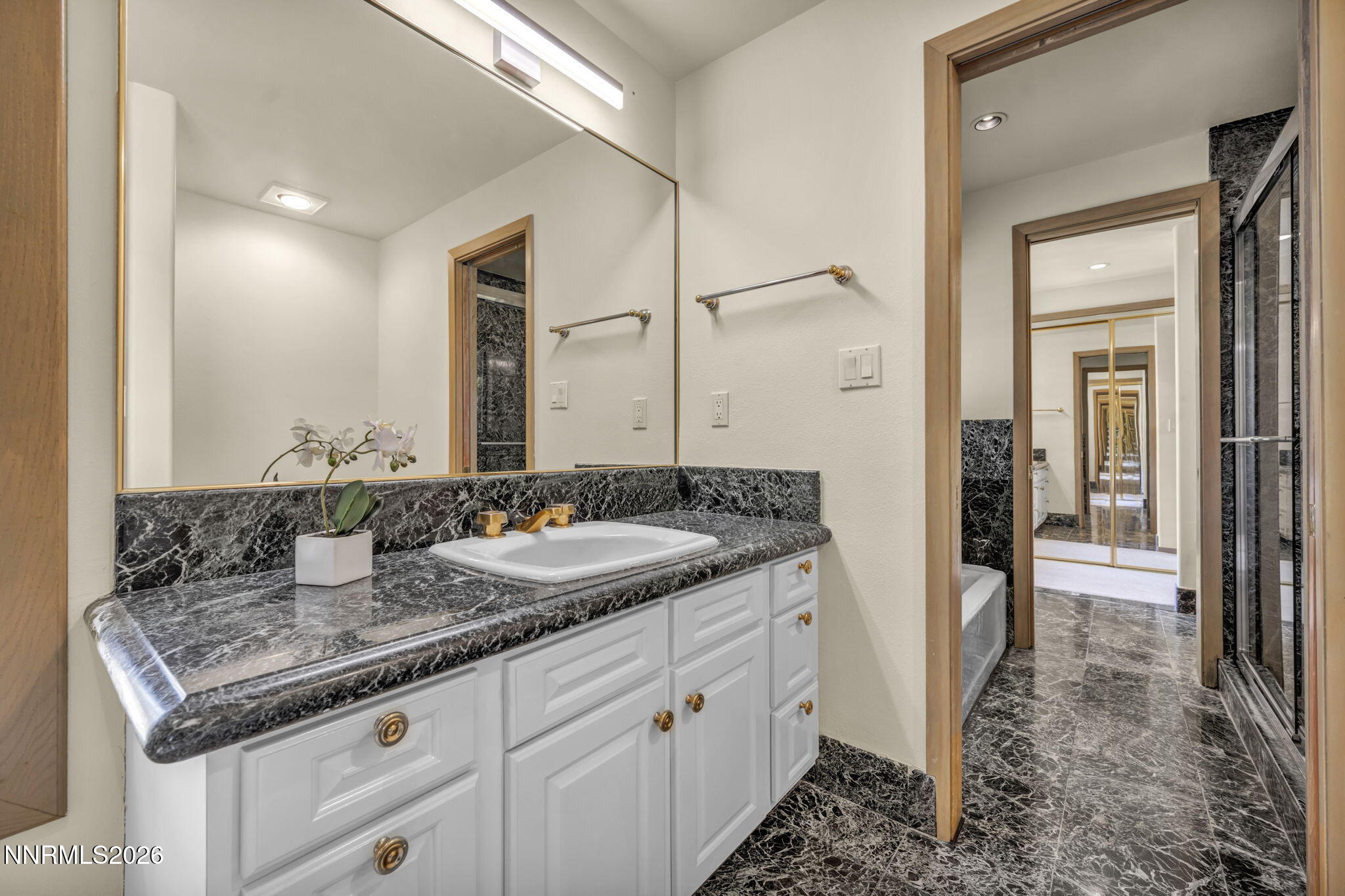 2570 Spinnaker Drive Reno, NV 89519 - Photo 24 of 41 a bathroom with a granite countertop sink and a mirror