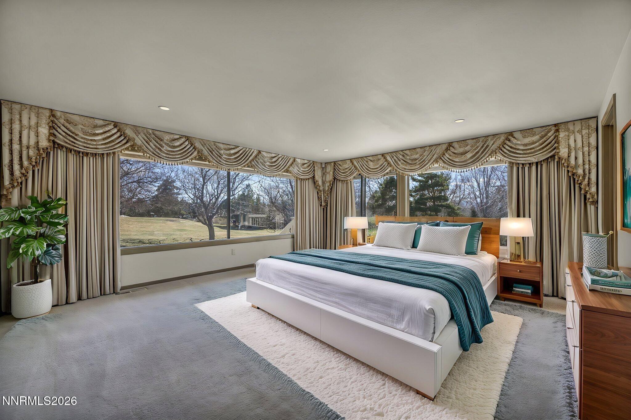 2570 Spinnaker Drive Reno, NV 89519 - Photo 6 of 41 a spacious bedroom with a bed and glass window