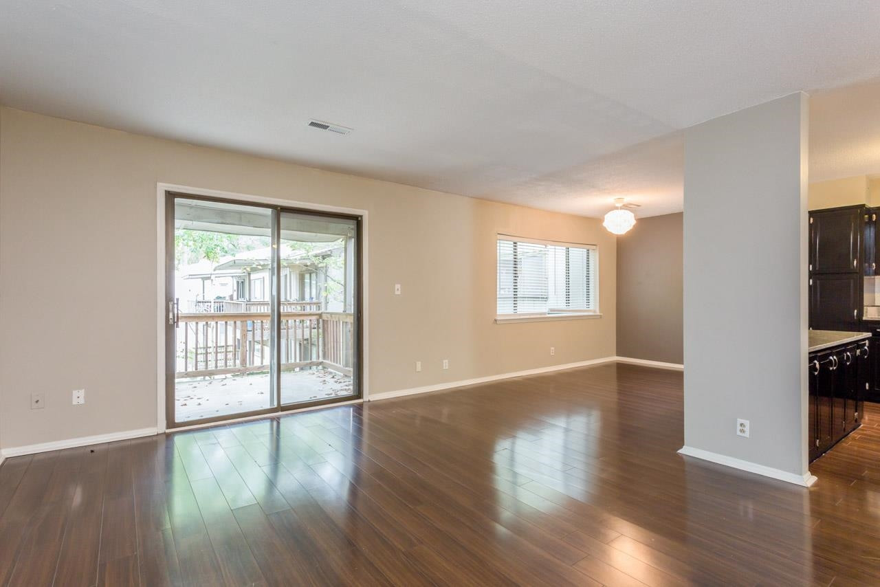 5036 Flint Ridge Place, Unit 5036 Raleigh, NC 27609 - Photo 1 of 18 a view of an empty room with window and wooden floor