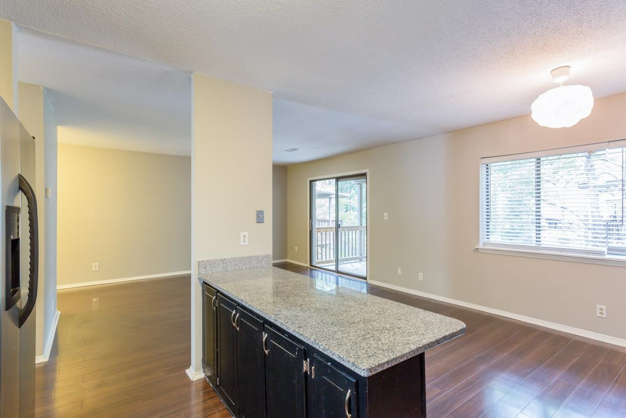 5036 Flint Ridge Place, Unit 5036 Raleigh, NC 27609 - Photo 5 of 18 an empty room with wooden floor and window