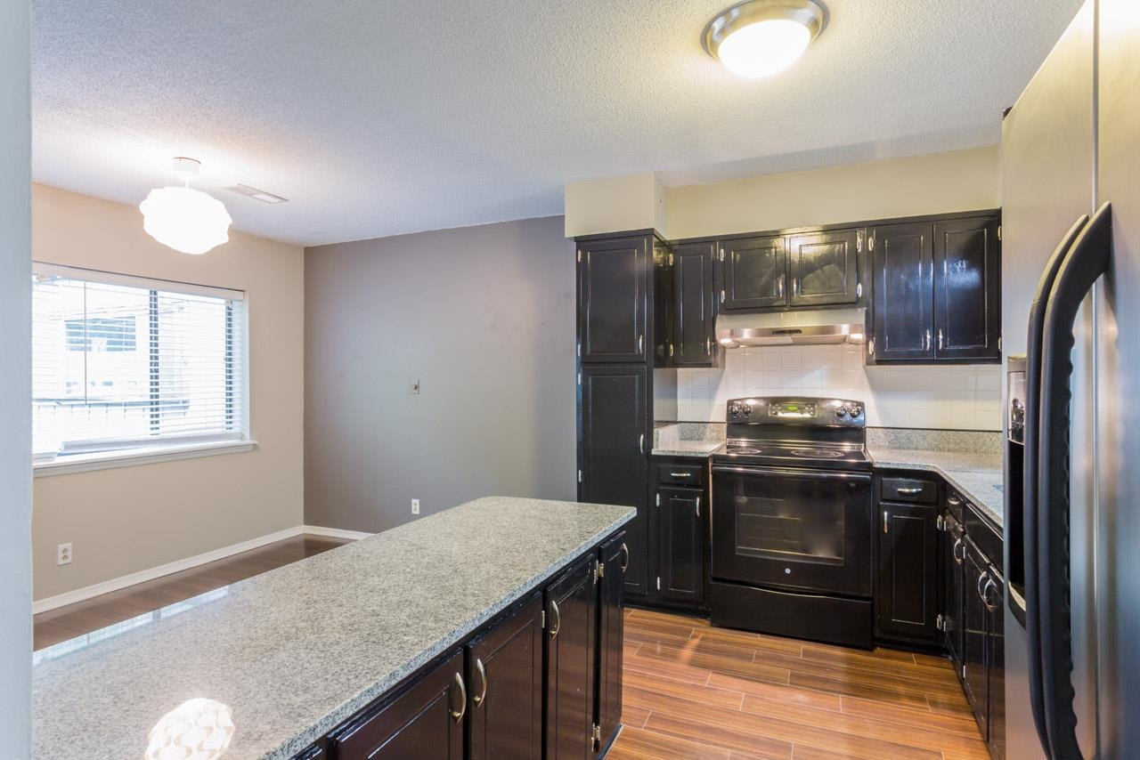 5036 Flint Ridge Place, Unit 5036 Raleigh, NC 27609 - Photo 8 of 18 a kitchen with stainless steel appliances granite countertop a stove a refrigerator and a sink
