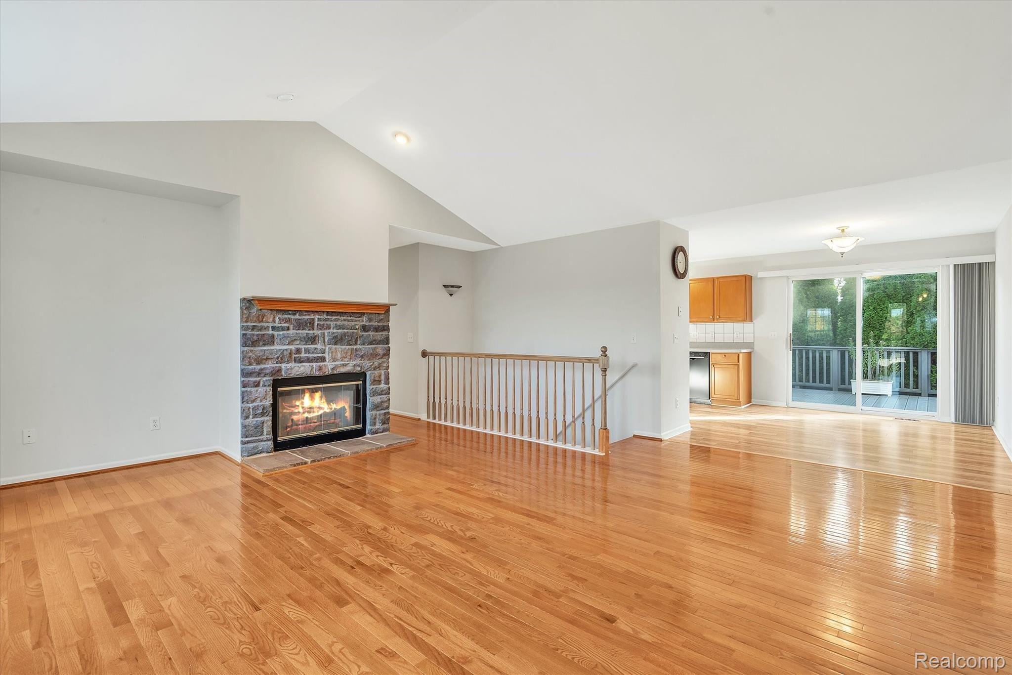 2874 Laurel Ridge Lane Howell, MI 48843 - Photo 5 of 34 Living room with stone clad gas fireplace, recessed lighting and a view into the dining area.