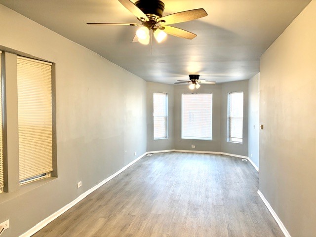 6631 South Justine Street Chicago, IL 60636 - Photo 3 of 18 wooden floor in an empty room with a window
