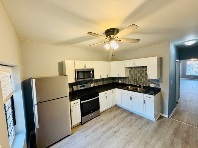 6631 South Justine Street Chicago, IL 60636 - Photo 6 of 18 a kitchen with stainless steel appliances granite countertop a refrigerator a stove top oven a sink and dishwasher