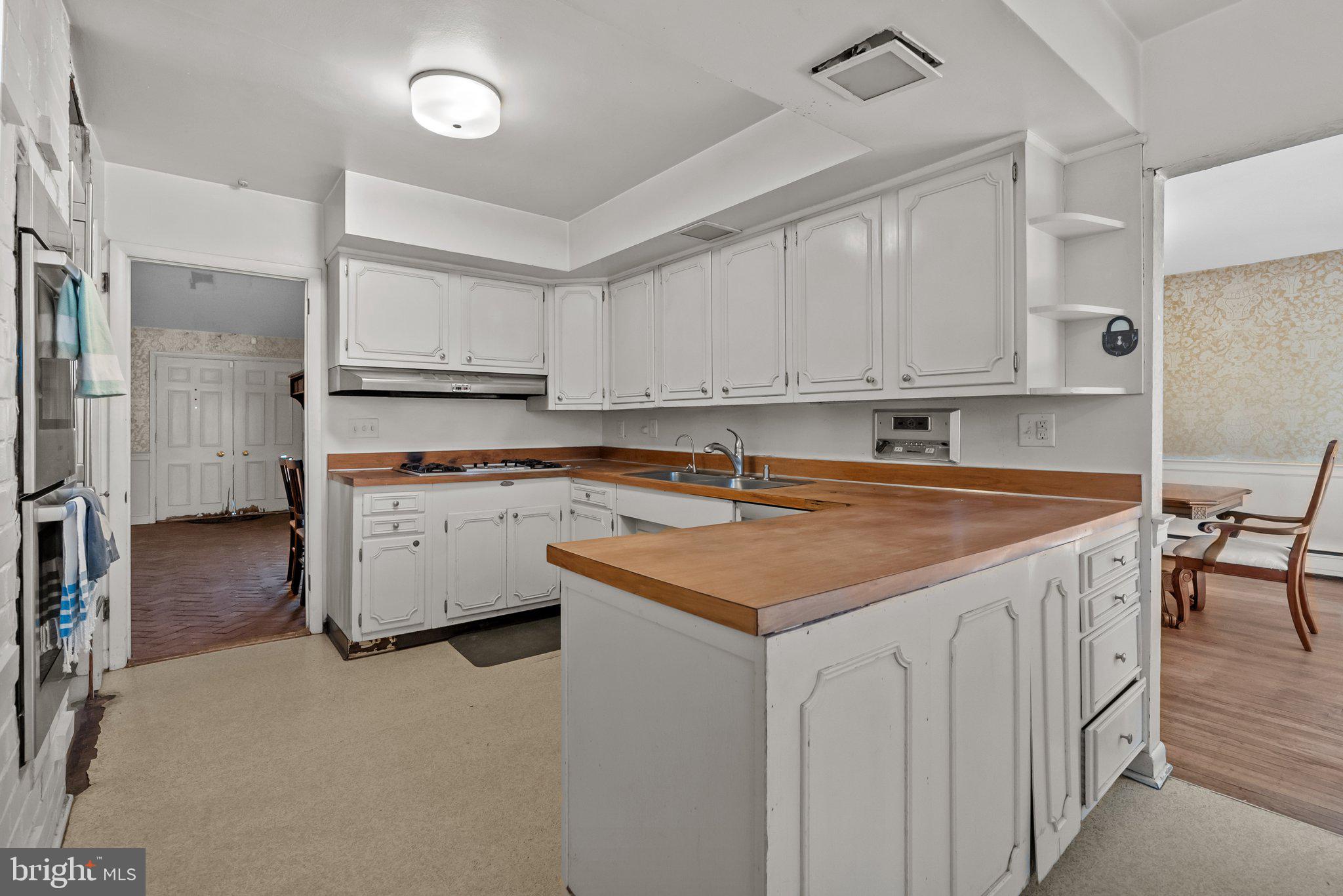 326 Hidden River Road Penn Valley, PA 19072 - Photo 18 of 56 a kitchen with stainless steel appliances a sink a stove a refrigerator cabinets and a center island