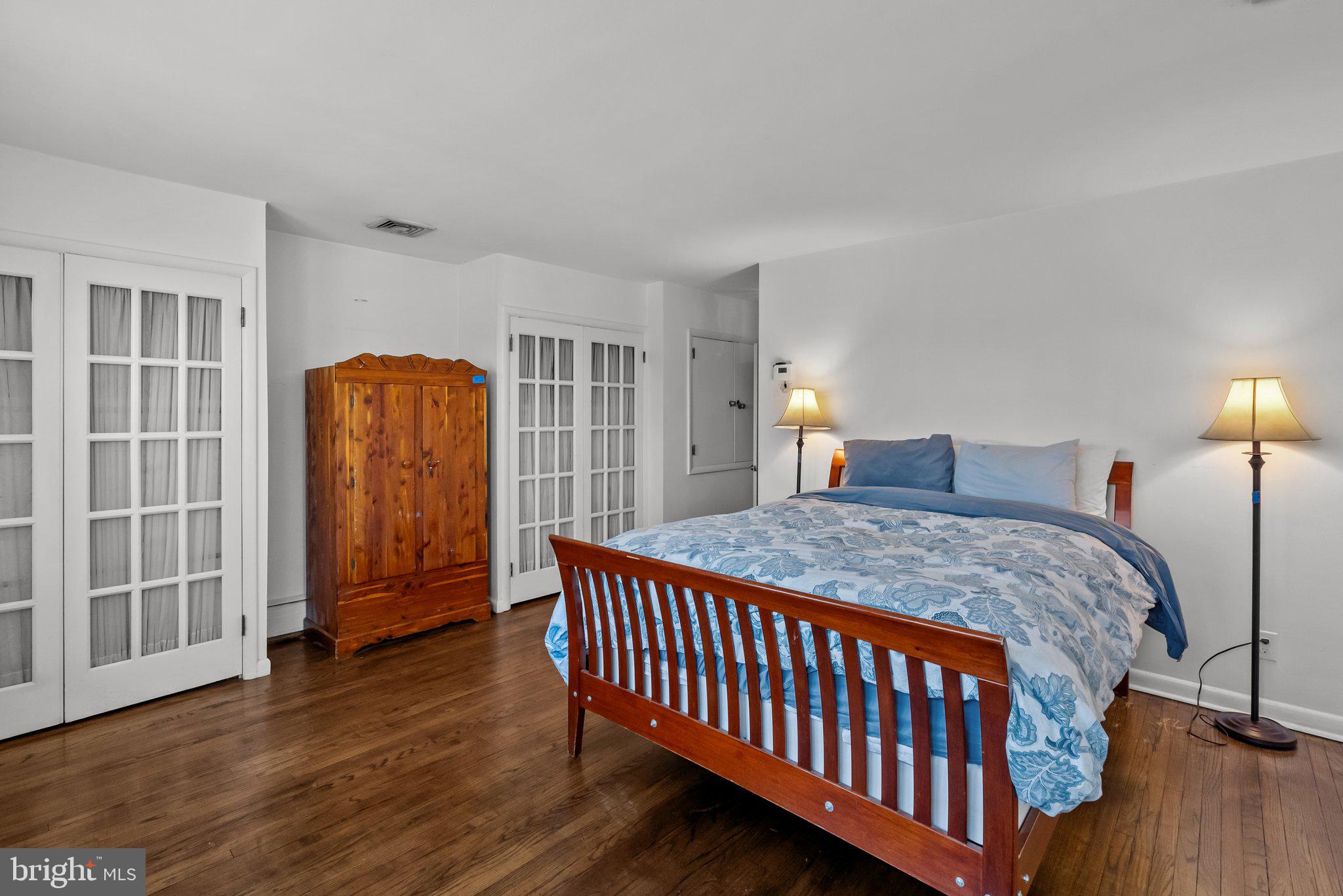 326 Hidden River Road Penn Valley, PA 19072 - Photo 20 of 56 a bedroom with a bed and wooden floor