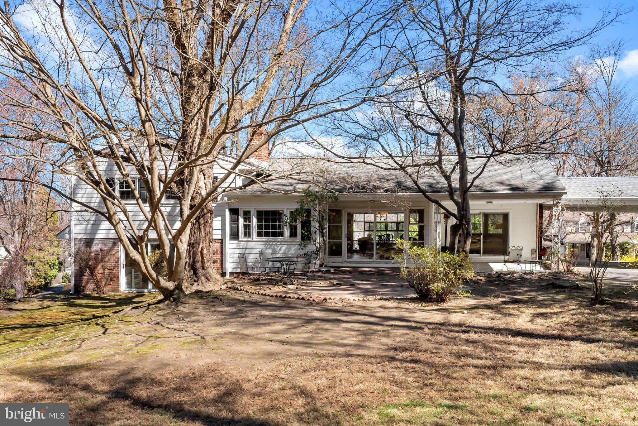326 Hidden River Road Penn Valley, PA 19072 - Photo 35 of 56 a front view of a house with a yard covered with trees