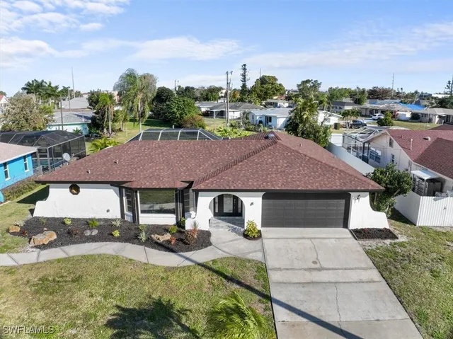 a aerial view of a house with swimming pool and a yard