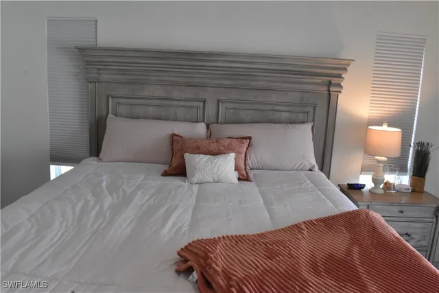 a bedroom with a bed and a lamp