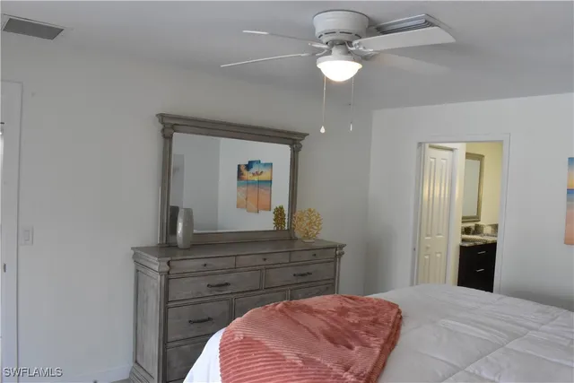 a bedroom with a bed and a dresser