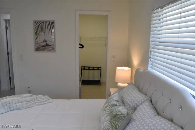 a bedroom with a bed and a painting on the wall