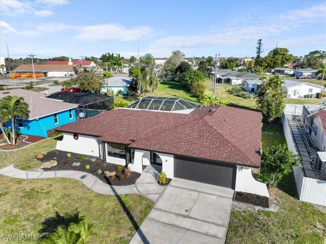 an aerial view of a house with yard swimming pool and outdoor seating