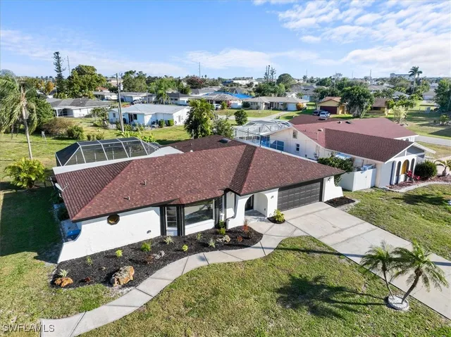 an aerial view of a house with garden space and street view