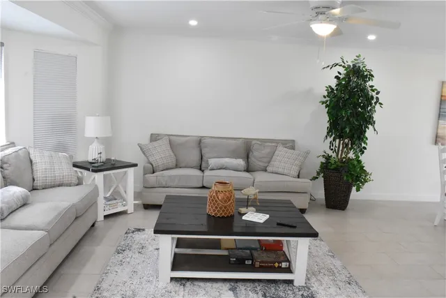 a living room with furniture and a potted plant