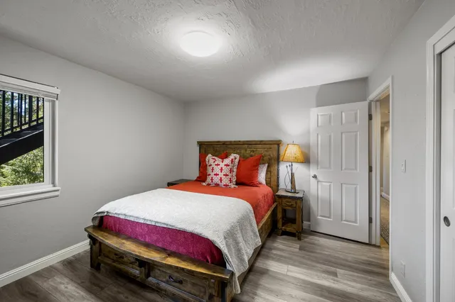 a bedroom with a bed and wooden floor