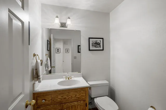 a bathroom with a toilet sink and mirror