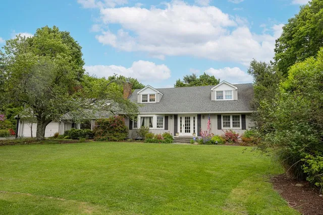 a front view of house with yard and green space