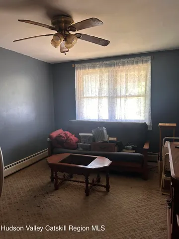 a living room with furniture a window and a projector