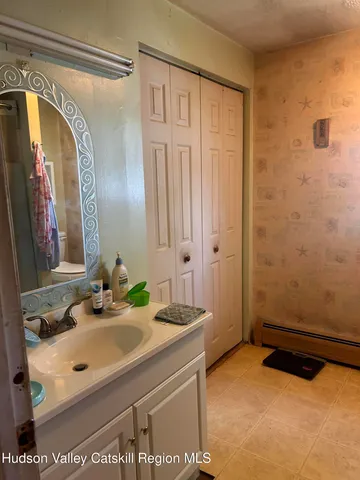 a bathroom with a sink and a mirror