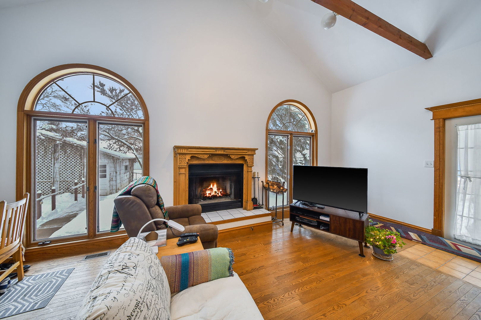 116 South Wright Street Naperville, IL 60540 - Photo 18 of 49 a living room with furniture a flat screen tv and a fireplace