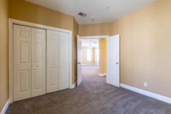 a spacious bathroom with a double vanity sink and a toilet