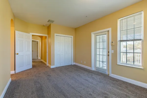 a view of a porch with wooden floor and fence