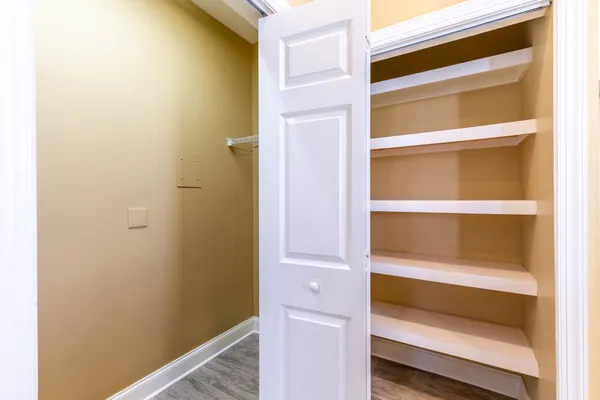 an empty room with closet area