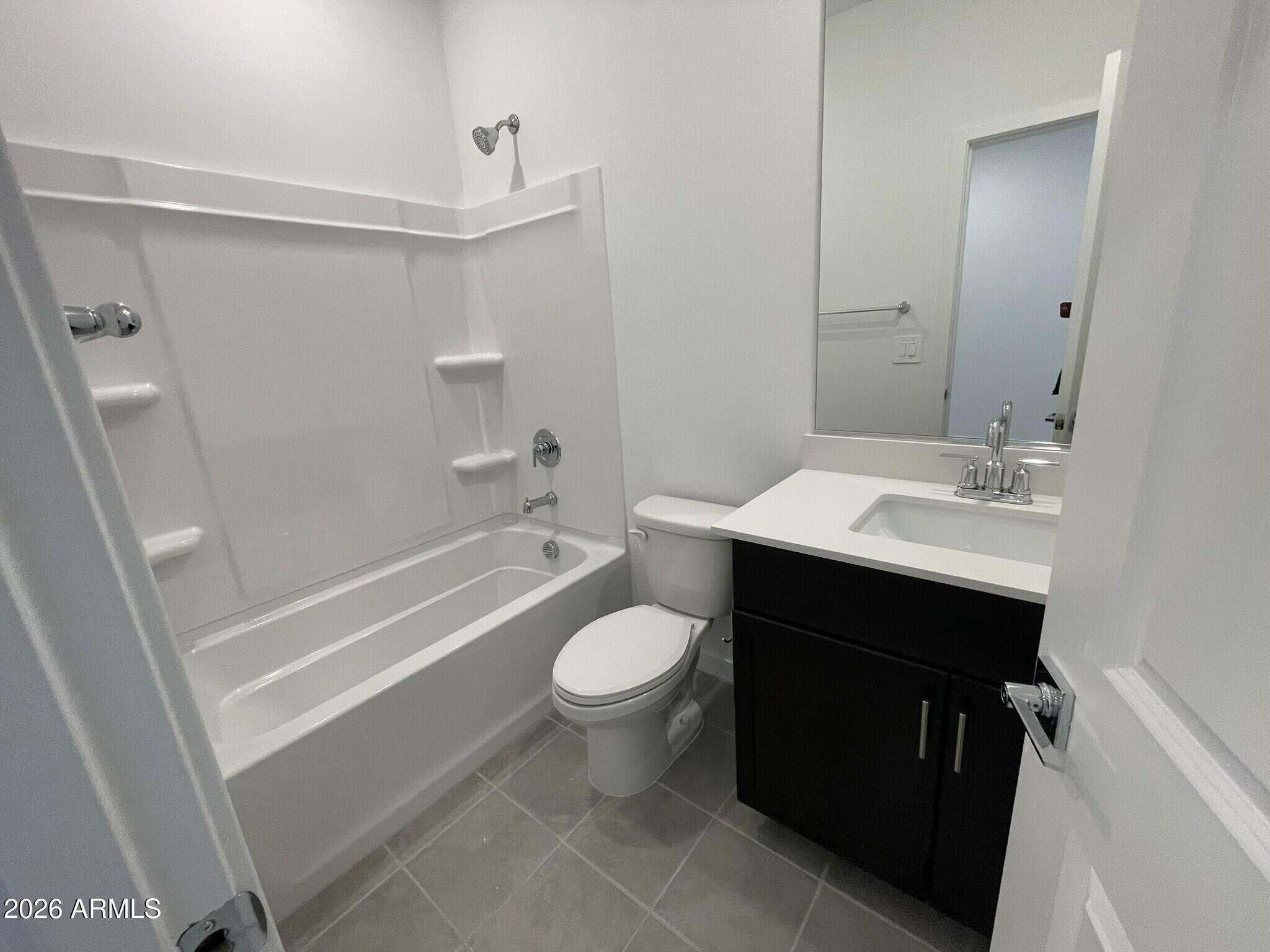 37014 West Prado Street Maricopa, AZ 85138 - Photo 6 of 18 a bathroom with a sink a toilet and shower