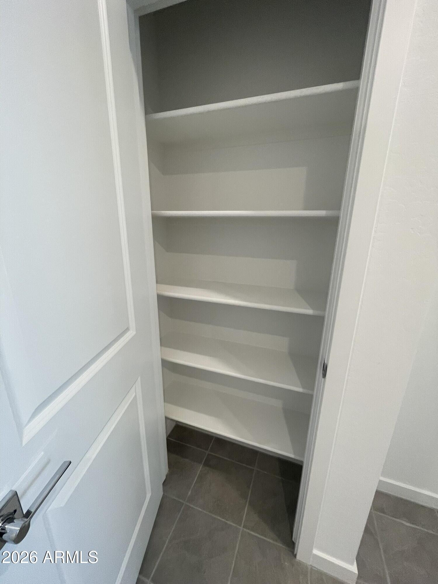 37014 West Prado Street Maricopa, AZ 85138 - Photo 8 of 18 a view of walk in closet with empty racks