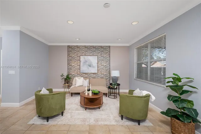 a living room with furniture and a potted plant