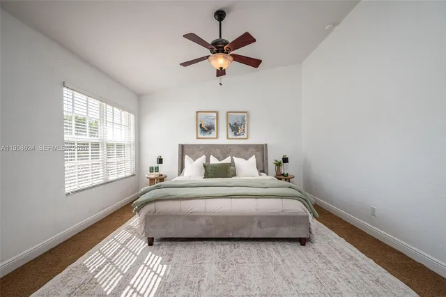 a bedroom with a large bed and a window